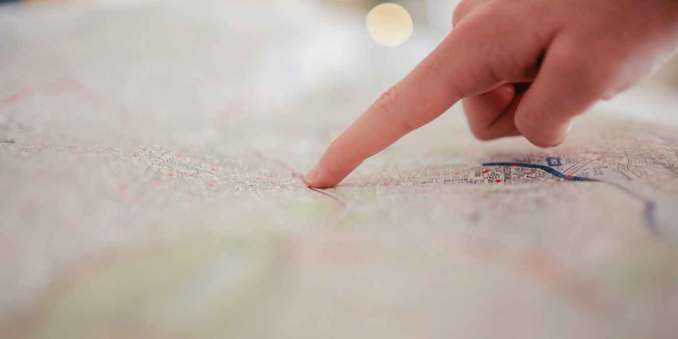 Person Pointing at a Map